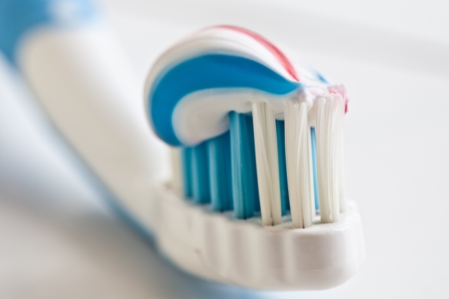 Toothbrush and toothpaste closeup.
